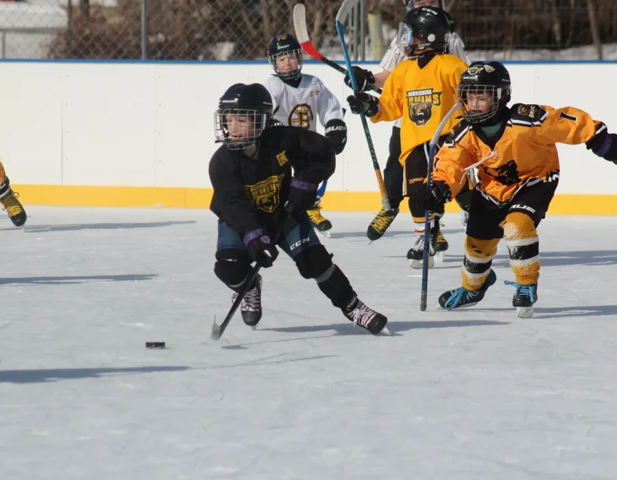 Hockey players and community members gathered at an outdoor rink